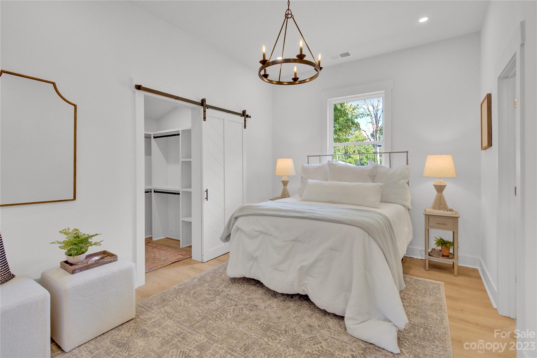 115 Ashe Street York, SC 29745 - Photo 16 of 33 a bedroom with a bed and a chandelier