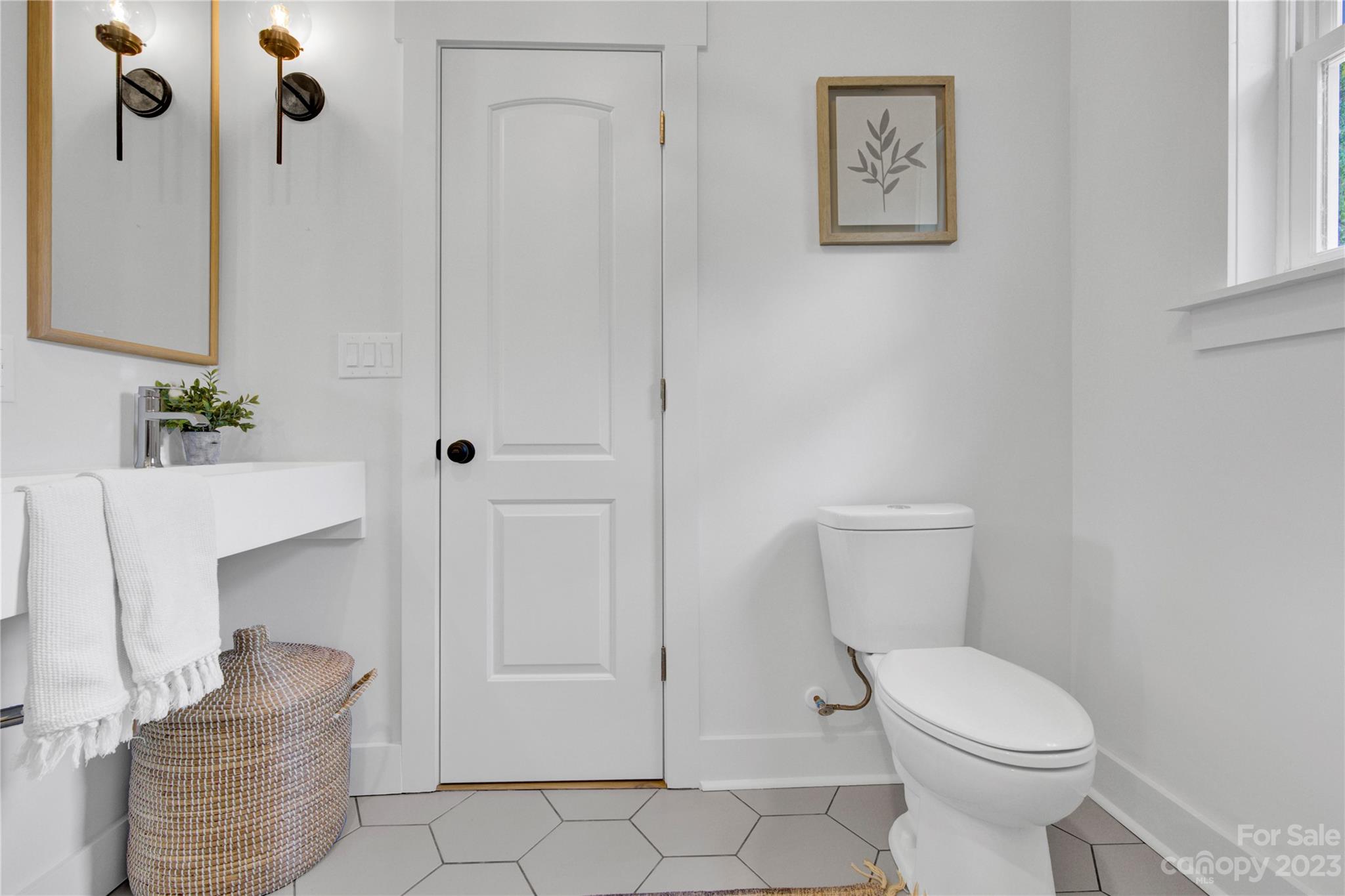 115 Ashe Street York, SC 29745 - Photo 22 of 33 a white toilet sitting next to a bathroom sink