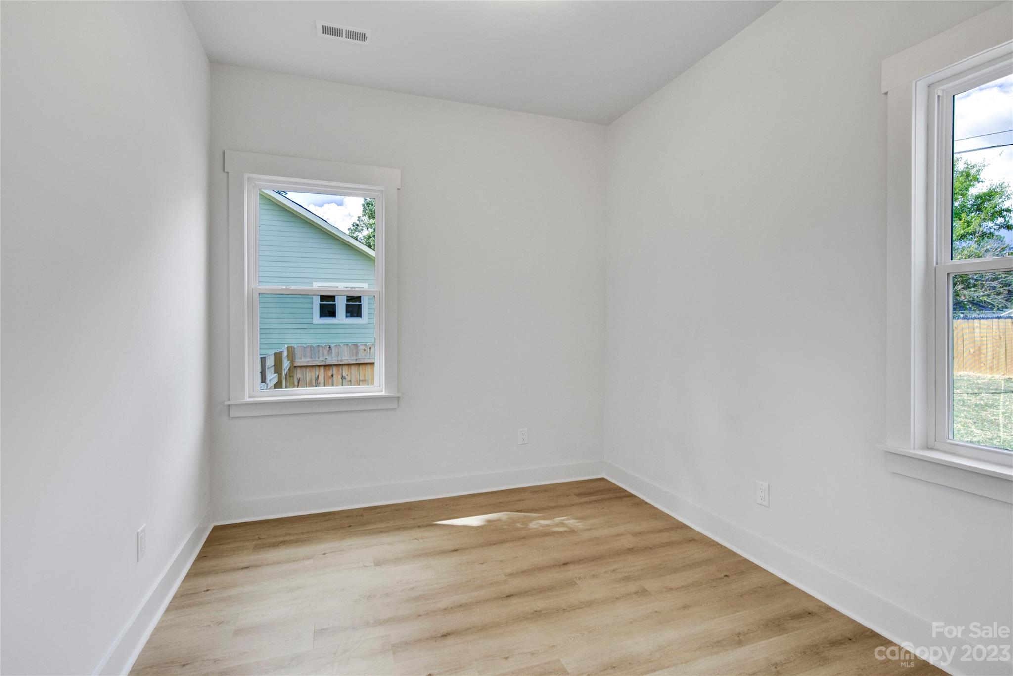 115 Ashe Street York, SC 29745 - Photo 23 of 33 an empty room with wooden floor and windows