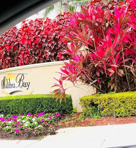 a sign that is in front of flowers