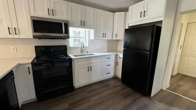 a kitchen with a refrigerator stove and microwave