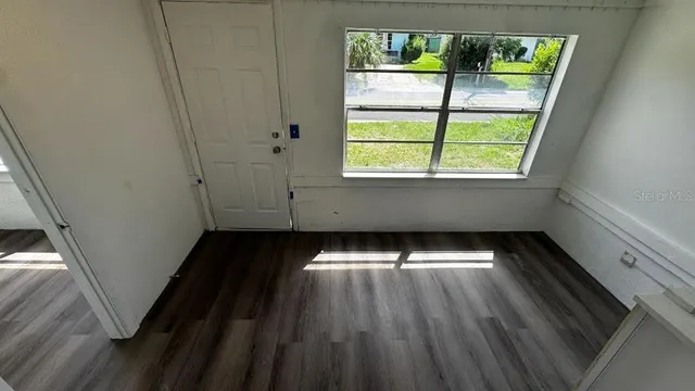 a view of an empty room with a window