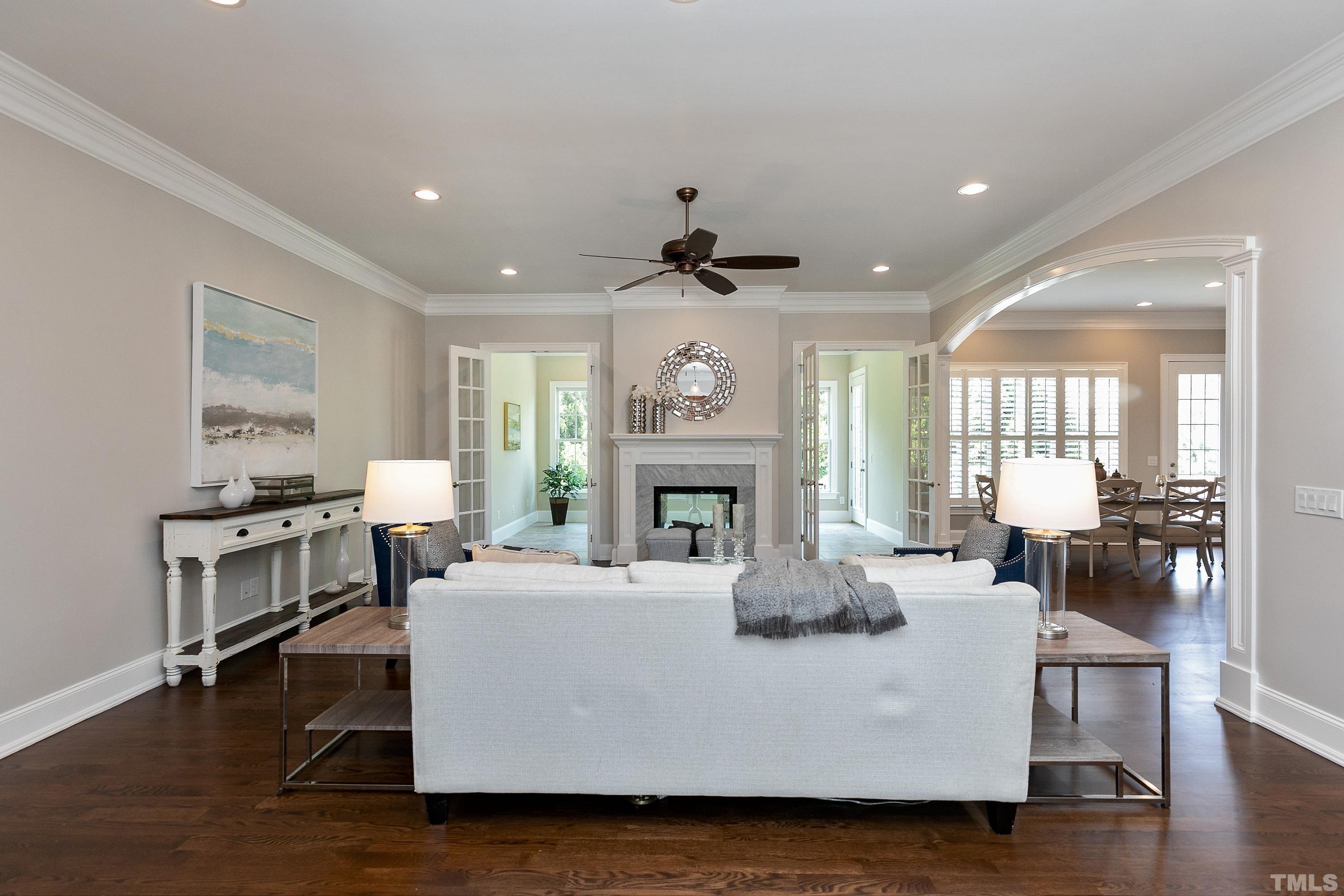 302 Michelangelo Way Cary, NC 27518 - Photo 15 of 44 a living room with furniture a fireplace and a table