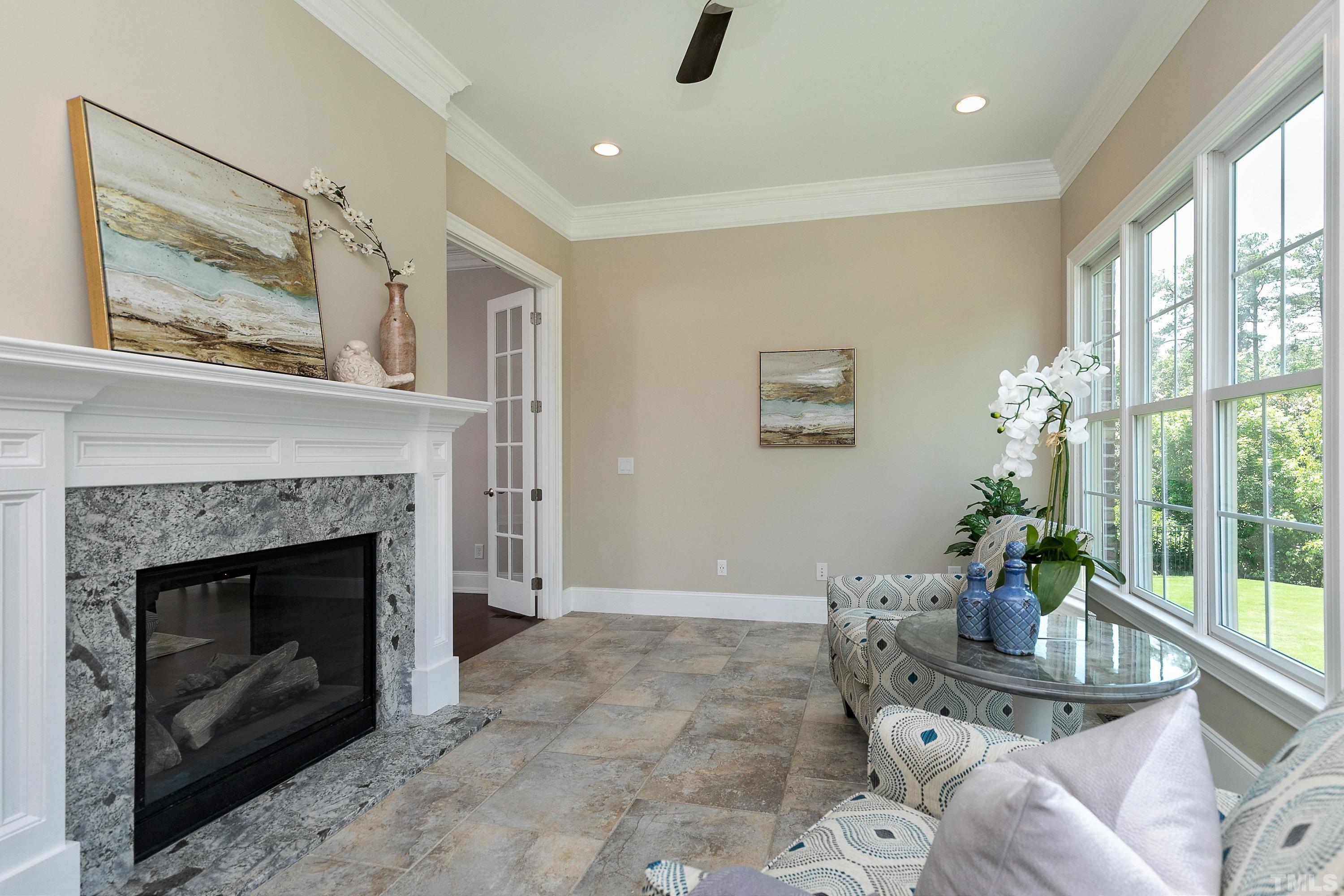 302 Michelangelo Way Cary, NC 27518 - Photo 18 of 44 a living room with furniture a window and a fireplace