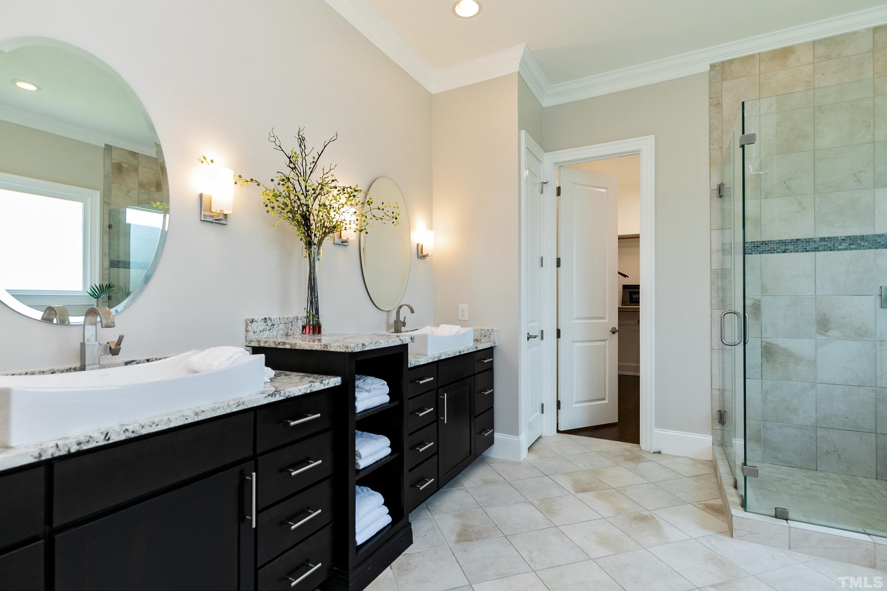 302 Michelangelo Way Cary, NC 27518 - Photo 25 of 44 a bathroom with a granite countertop sink a mirror and a shower