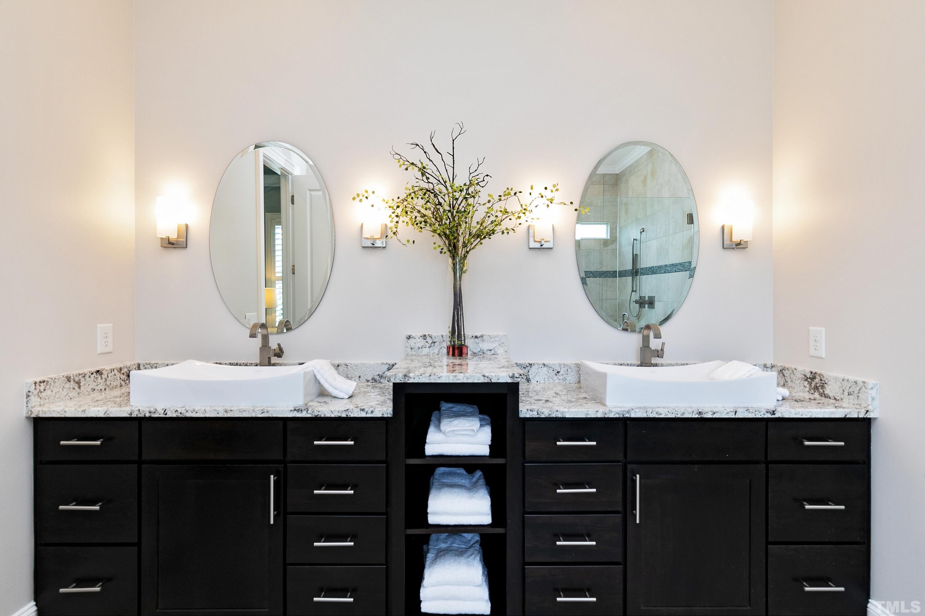 302 Michelangelo Way Cary, NC 27518 - Photo 27 of 44 a bathroom with double vanity and a mirror