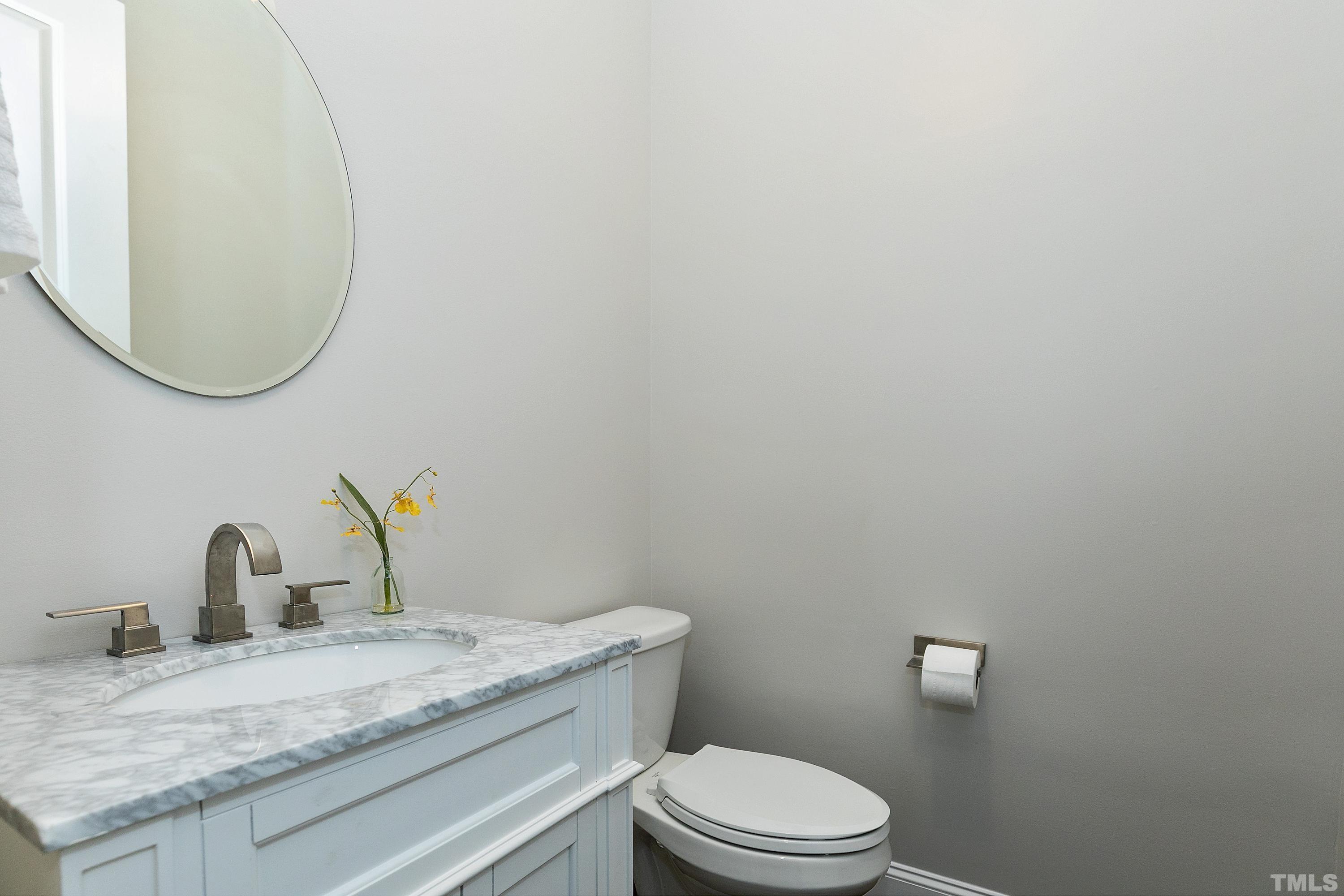 302 Michelangelo Way Cary, NC 27518 - Photo 28 of 44 a bathroom with a granite countertop toilet a sink and mirror