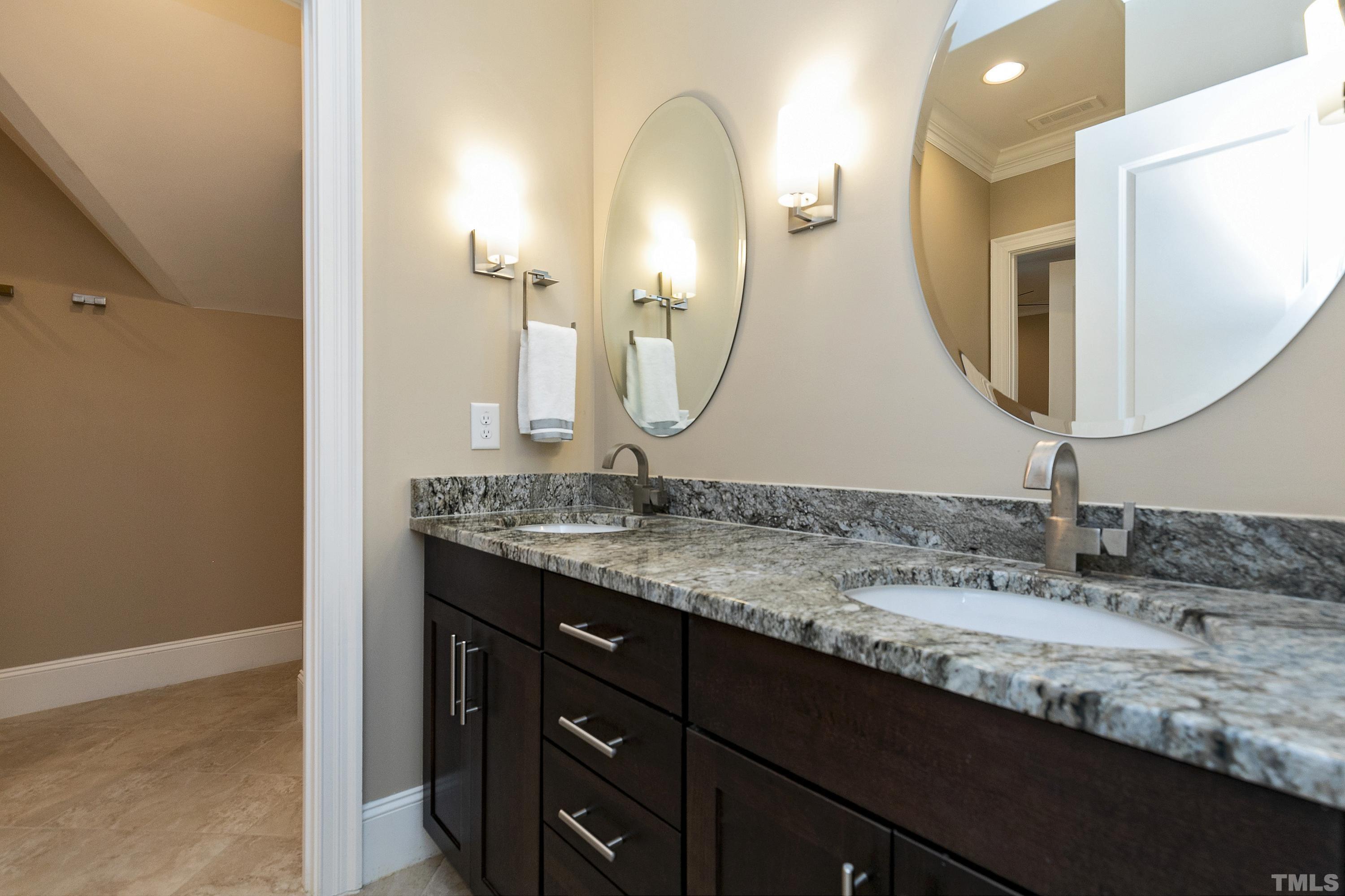 302 Michelangelo Way Cary, NC 27518 - Photo 29 of 44 a bathroom with a double vanity sink and a mirror