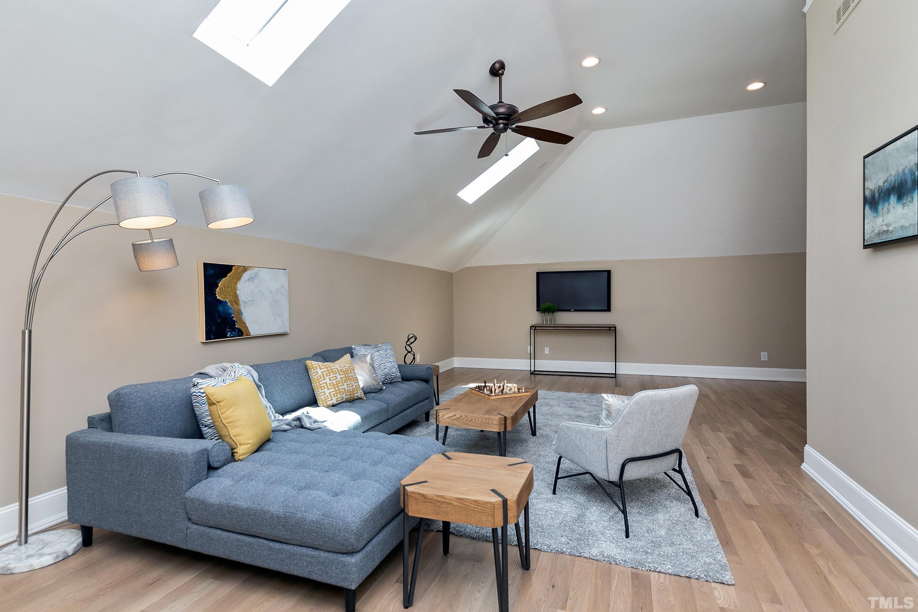302 Michelangelo Way Cary, NC 27518 - Photo 31 of 44 a living room with furniture and a wooden floor