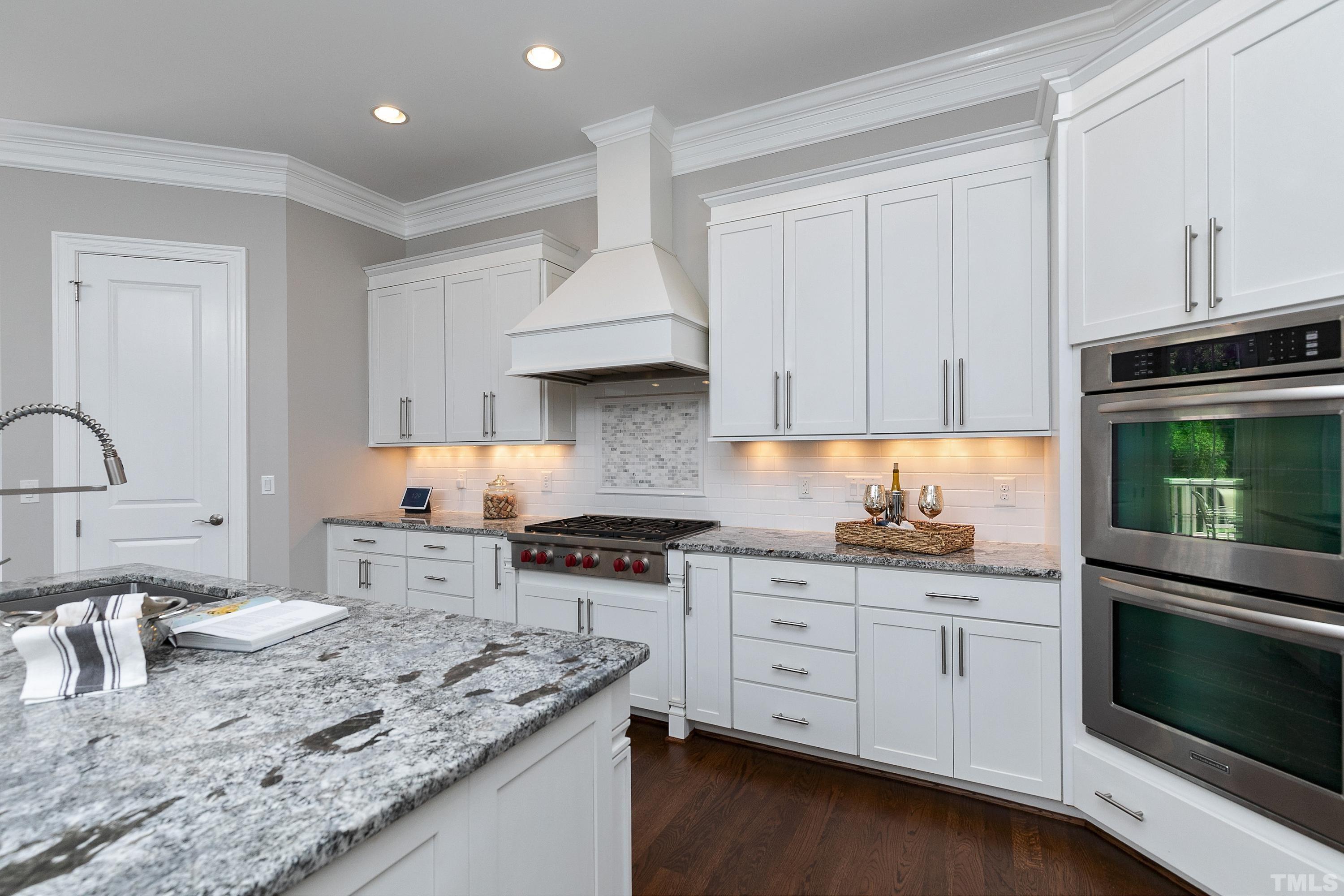 302 Michelangelo Way Cary, NC 27518 - Photo 7 of 44 a kitchen with granite countertop a stove sink and cabinets
