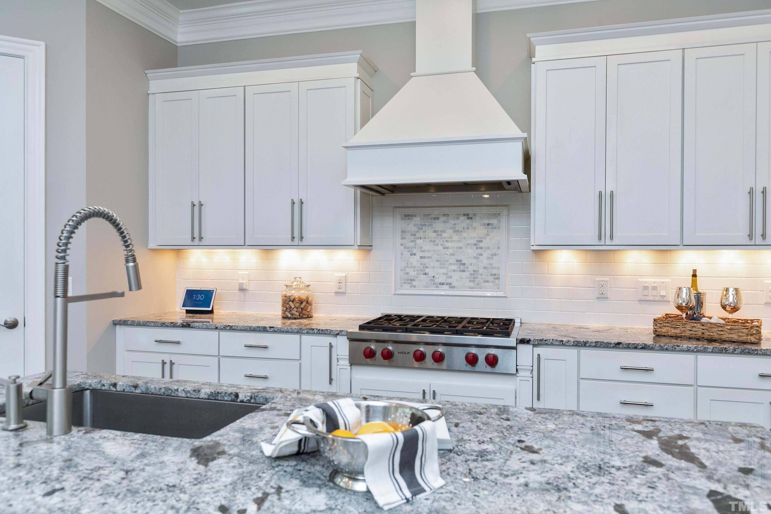 302 Michelangelo Way Cary, NC 27518 - Photo 8 of 44 a kitchen with a stove a sink and cabinets