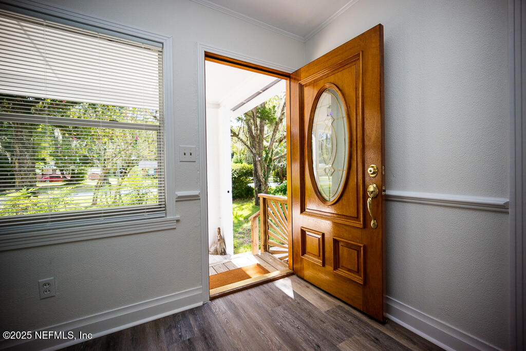 9965 Arnold Road Jacksonville, FL 32246 - Photo 14 of 60 a living room with furniture a fireplace and a large window