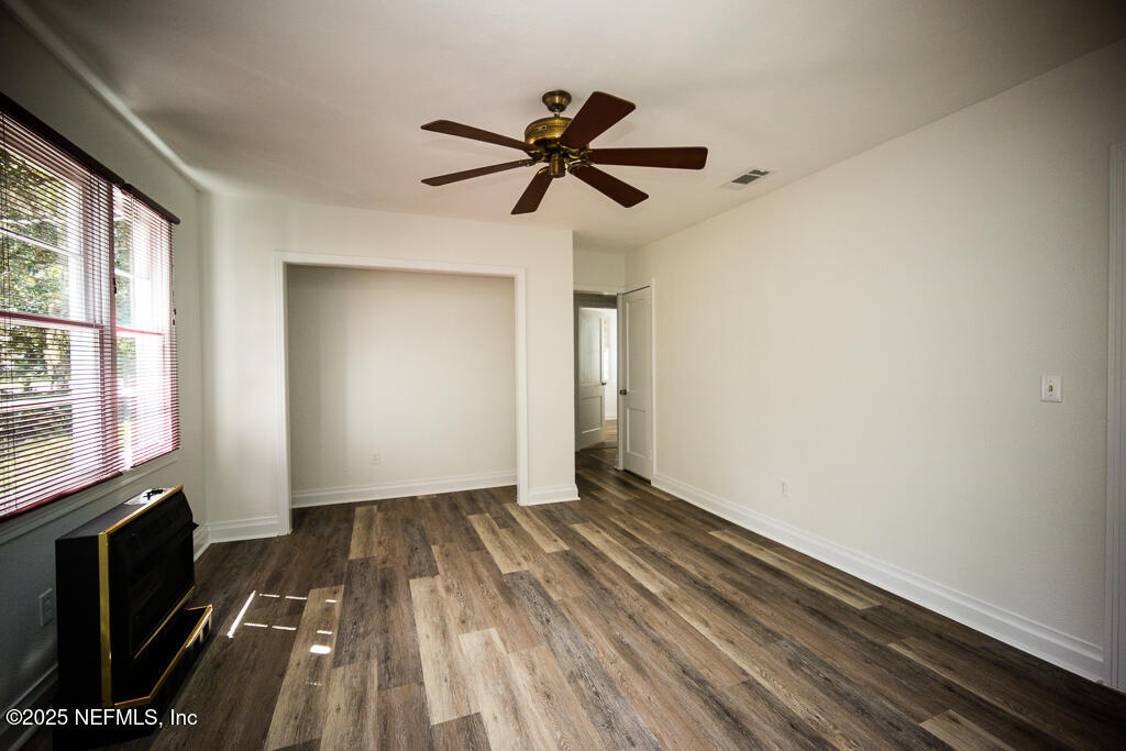 9965 Arnold Road Jacksonville, FL 32246 - Photo 19 of 60 a view of empty room with wooden floor and fan