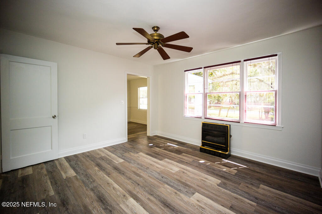 9965 Arnold Road Jacksonville, FL 32246 - Photo 21 of 60 a view of empty room with wooden floor and fan