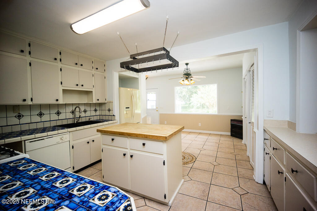 9965 Arnold Road Jacksonville, FL 32246 - Photo 26 of 60 a kitchen with a stove sink and cabinets