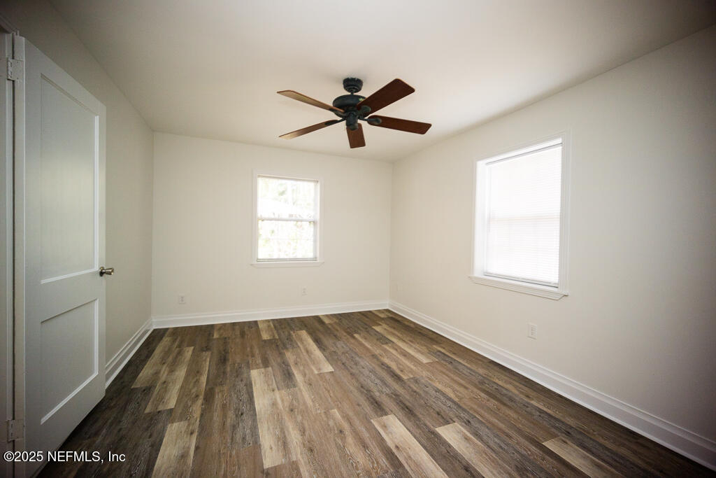 9965 Arnold Road Jacksonville, FL 32246 - Photo 29 of 60 a view of empty room with wooden floor and fan
