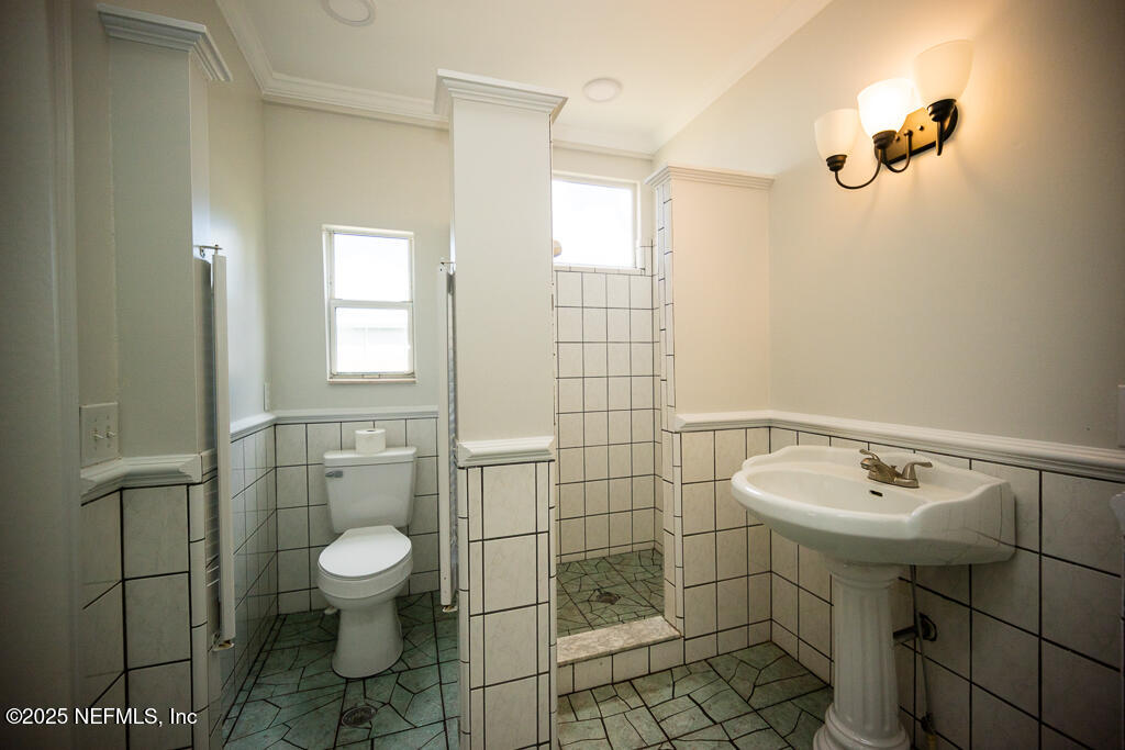 9965 Arnold Road Jacksonville, FL 32246 - Photo 31 of 60 a bathroom with a sink toilet and shower