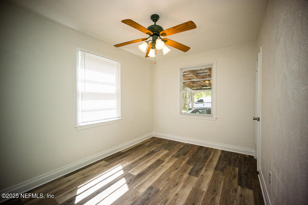 9965 Arnold Road Jacksonville, FL 32246 - Photo 34 of 60 a view of an empty room with wooden floor and a window