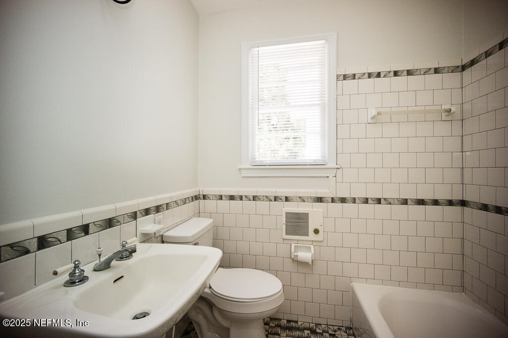 9965 Arnold Road Jacksonville, FL 32246 - Photo 35 of 60 a bathroom with a sink a toilet and shower
