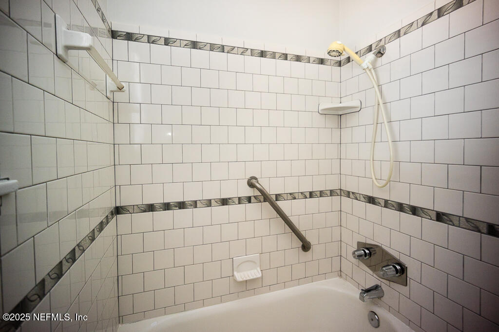 9965 Arnold Road Jacksonville, FL 32246 - Photo 36 of 60 a bathroom with a shower and a bathtub