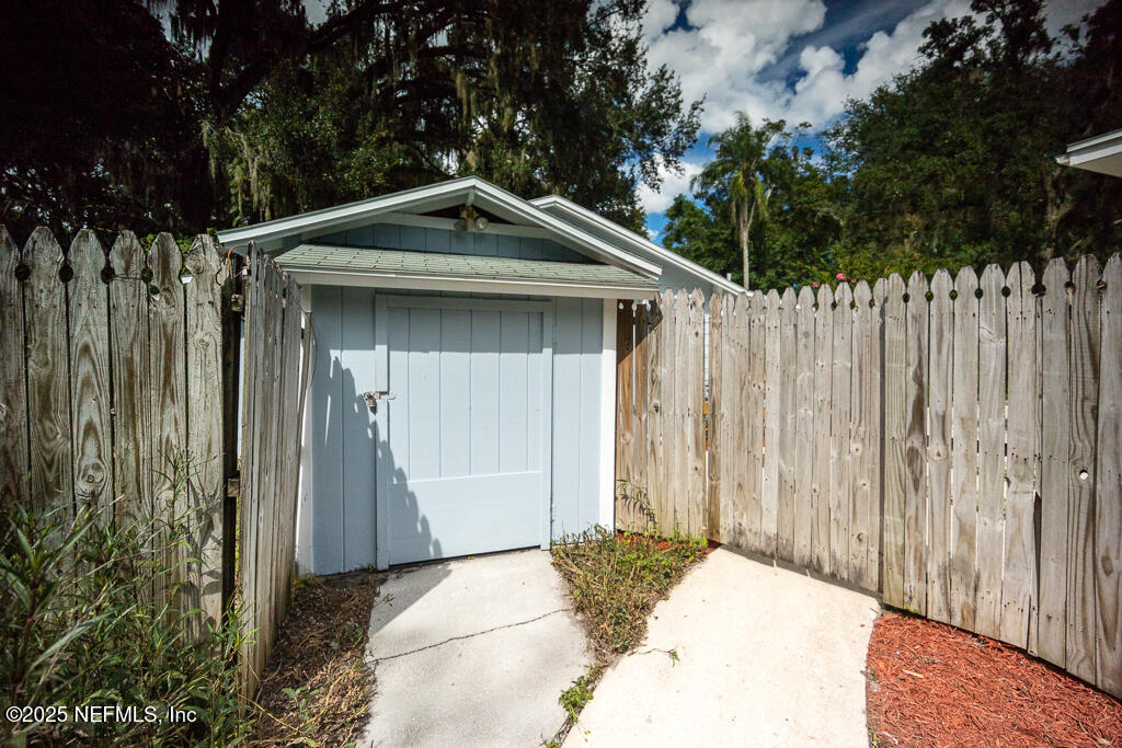 9965 Arnold Road Jacksonville, FL 32246 - Photo 39 of 60 a front view of a house with a garden