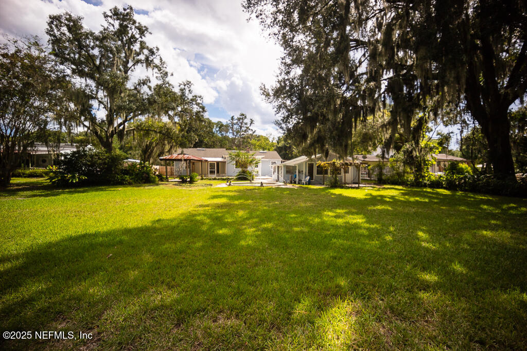 9965 Arnold Road Jacksonville, FL 32246 - Photo 49 of 60 a view of yard with swimming pool and trees