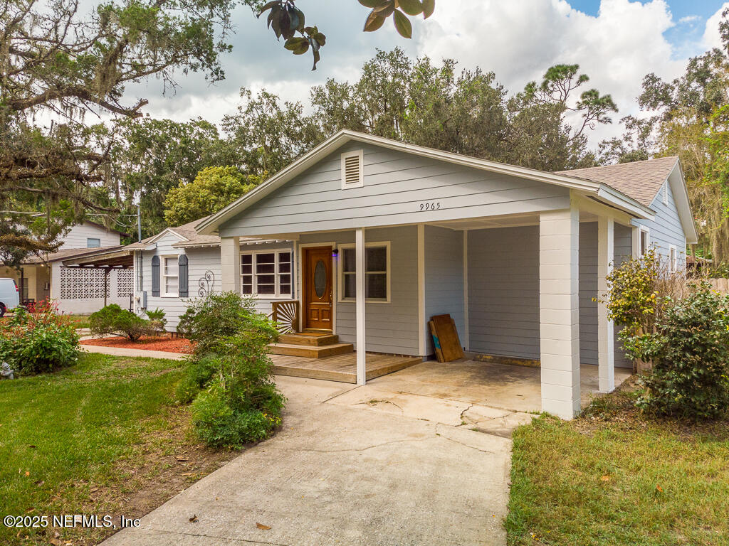 9965 Arnold Road Jacksonville, FL 32246 - Photo 5 of 60 a view of a house with yard and plants