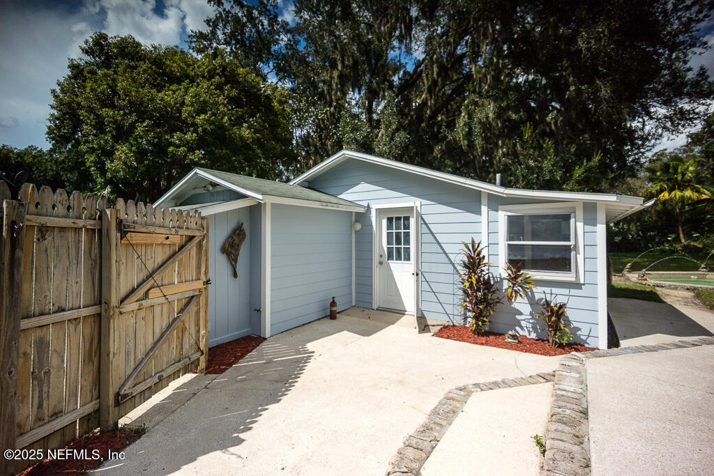 9965 Arnold Road Jacksonville, FL 32246 - Photo 51 of 60 a front view of a house with yard and seating space