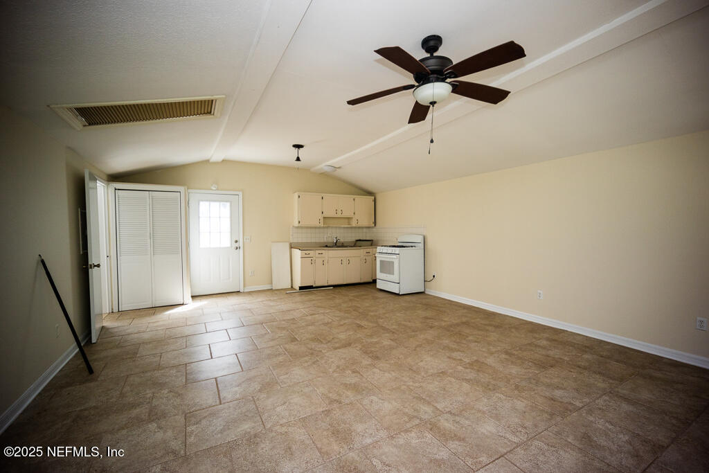 9965 Arnold Road Jacksonville, FL 32246 - Photo 55 of 60 a view of an empty room with a ceiling fan and window