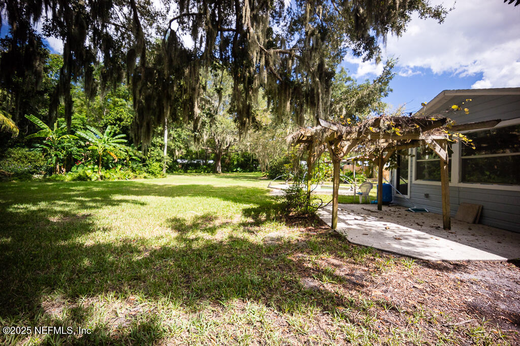 9965 Arnold Road Jacksonville, FL 32246 - Photo 59 of 60 a view of a yard with swimming pool
