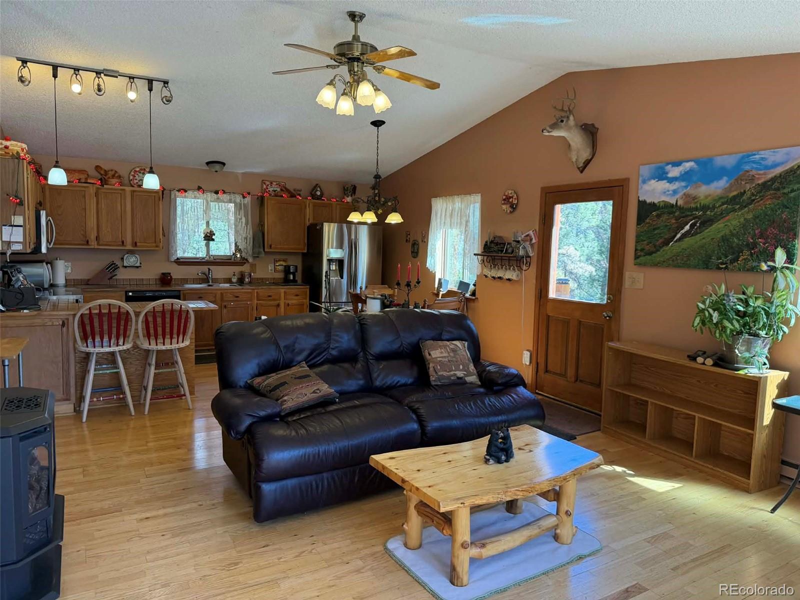 33623 Smith Road Pine, CO 80470 - Photo 2 of 45 a living room with furniture a chandelier and a dining table