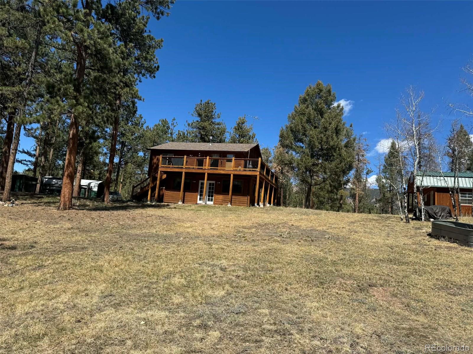 33623 Smith Road Pine, CO 80470 - Photo 25 of 45 a front view of a house with a yard