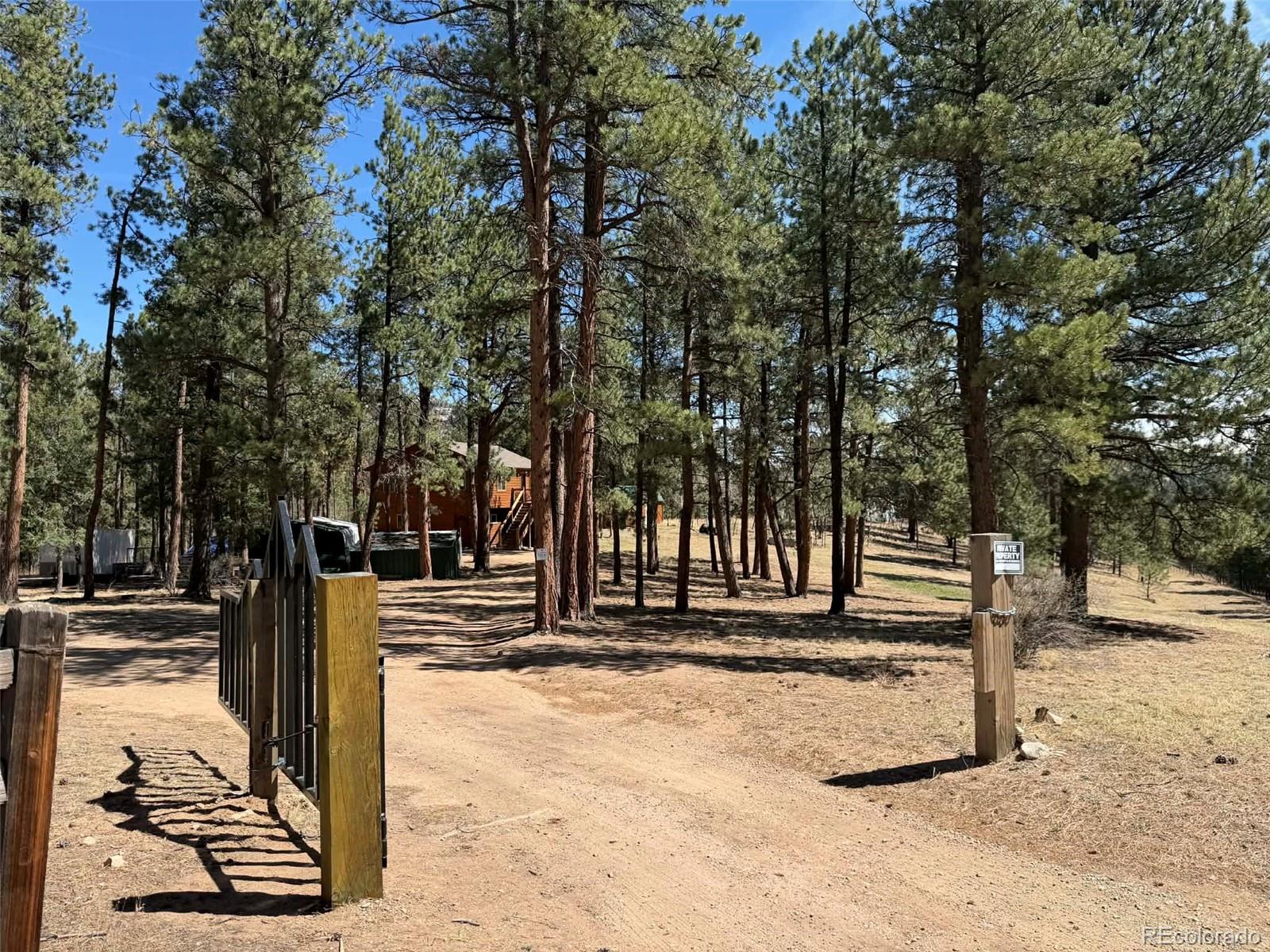 33623 Smith Road Pine, CO 80470 - Photo 34 of 45 a front view of a building with trees