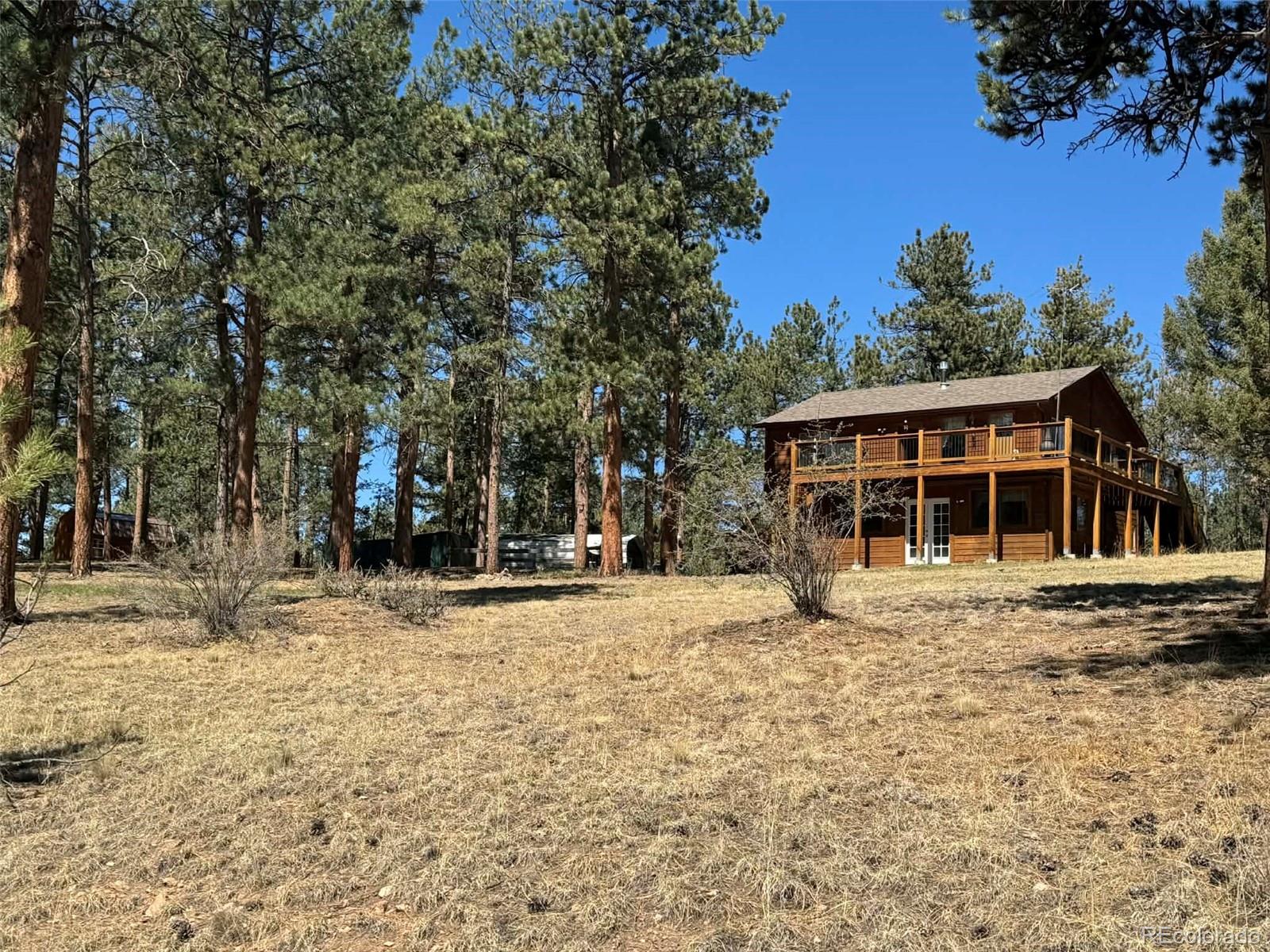 33623 Smith Road Pine, CO 80470 - Photo 39 of 45 a front view of a house with a yard
