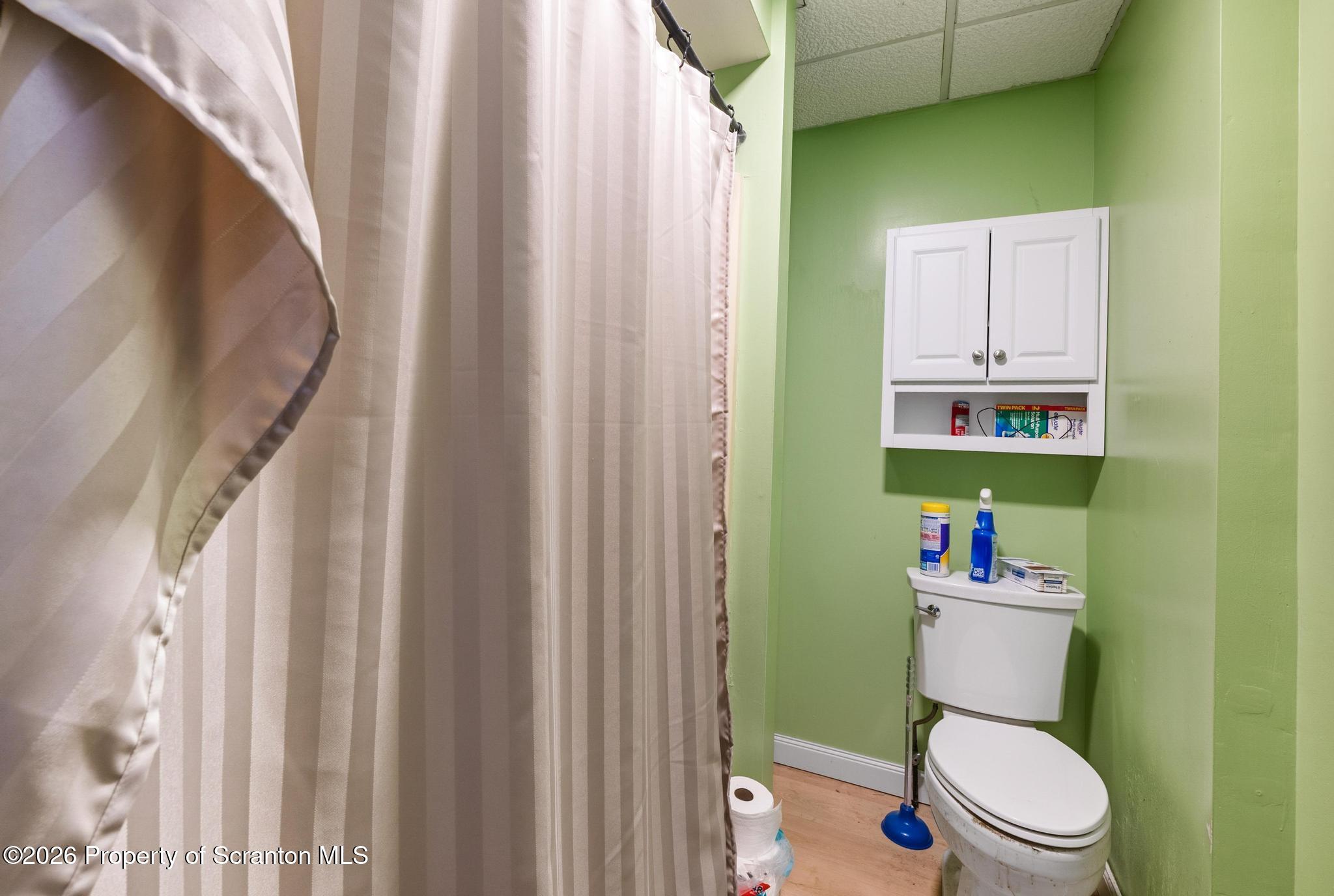 518 Prospect Avenue Scranton, PA 18505 - Photo 35 of 59 a white toilet sitting next to a shower curtain