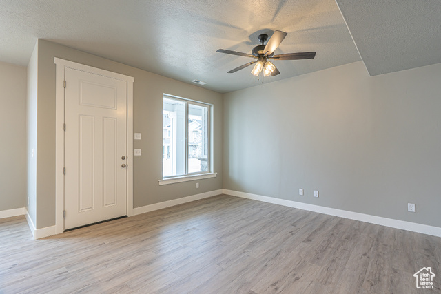 2242 South 1120 West, Unit 69 Logan, UT 84321 - Photo 11 of 26 Entrance foyer featuring a textured ceiling, light wood-type flooring, and a ceiling fan