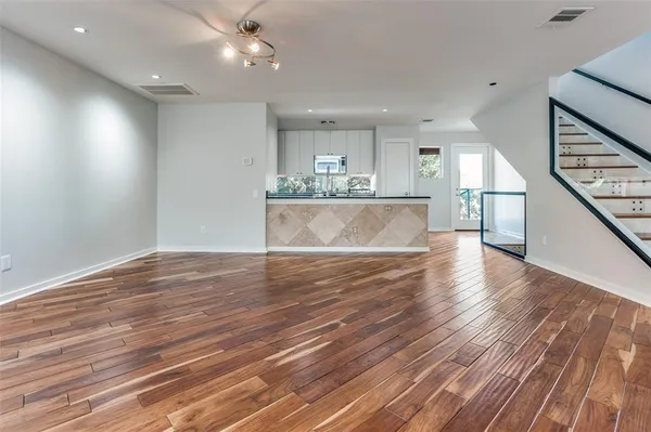 a view of kitchen and hall with wooden floor
