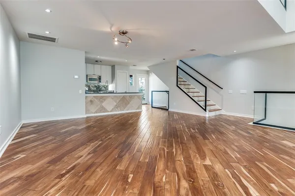 a view of a room with wooden floor and staircase
