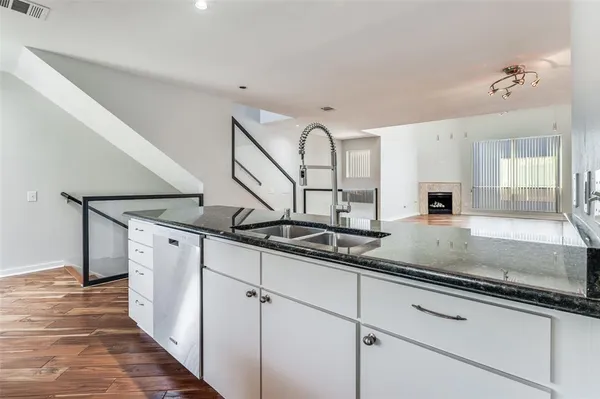 a kitchen with stainless steel appliances granite countertop a sink and cabinets