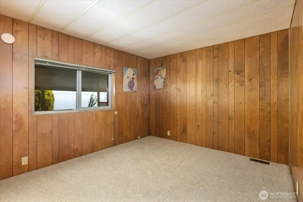 a view of an empty room with wooden walls