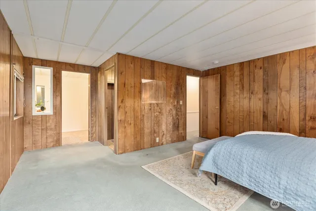 a bedroom with a large bed and a window