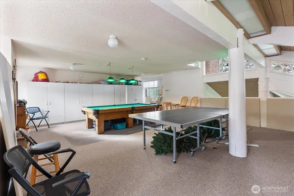 a living room with furniture a table and kitchen view