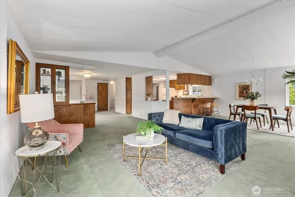 a living room with furniture and a dining table