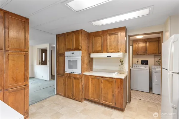 a kitchen with a refrigerator and cabinets