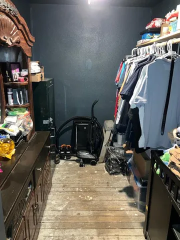 a bedroom with a bed and a small washing machine