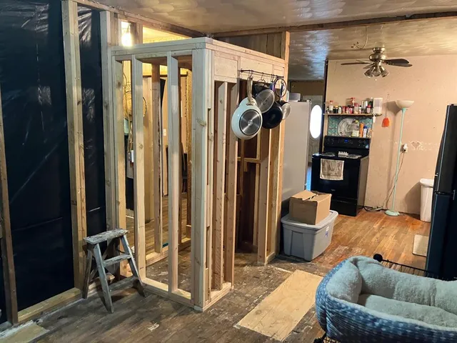 a room with water heater and wooden floor