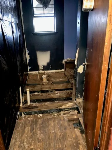 a bathroom with a sink mirror vanity and toilet