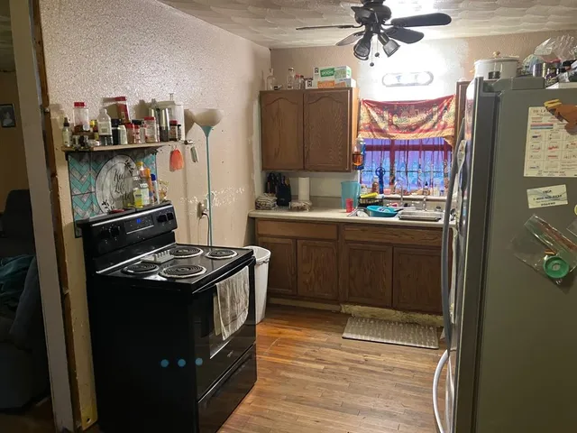 a kitchen with a sink and a stove top oven