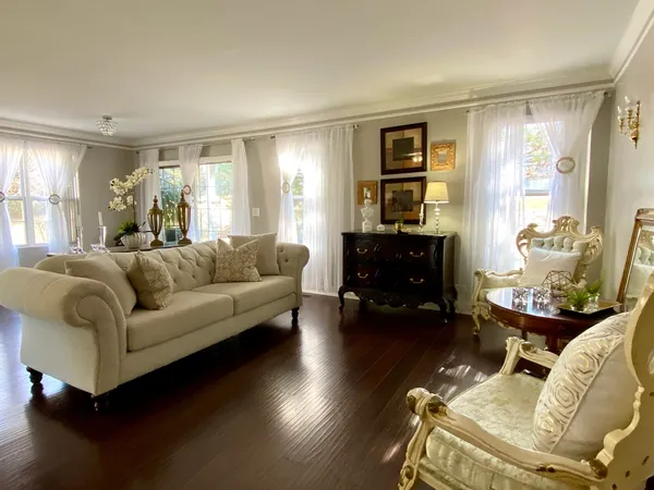 a living room with furniture and wooden floor