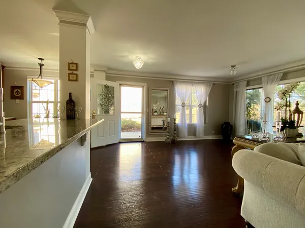 a living room with hardwood floor and a window
